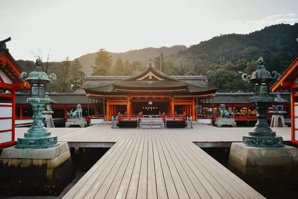a Japanese temple with mountains in the background