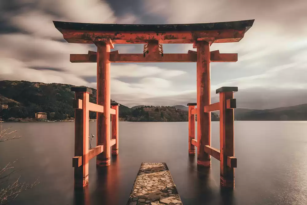 a torii gate outside of an ancient Shinto shrine in Japan